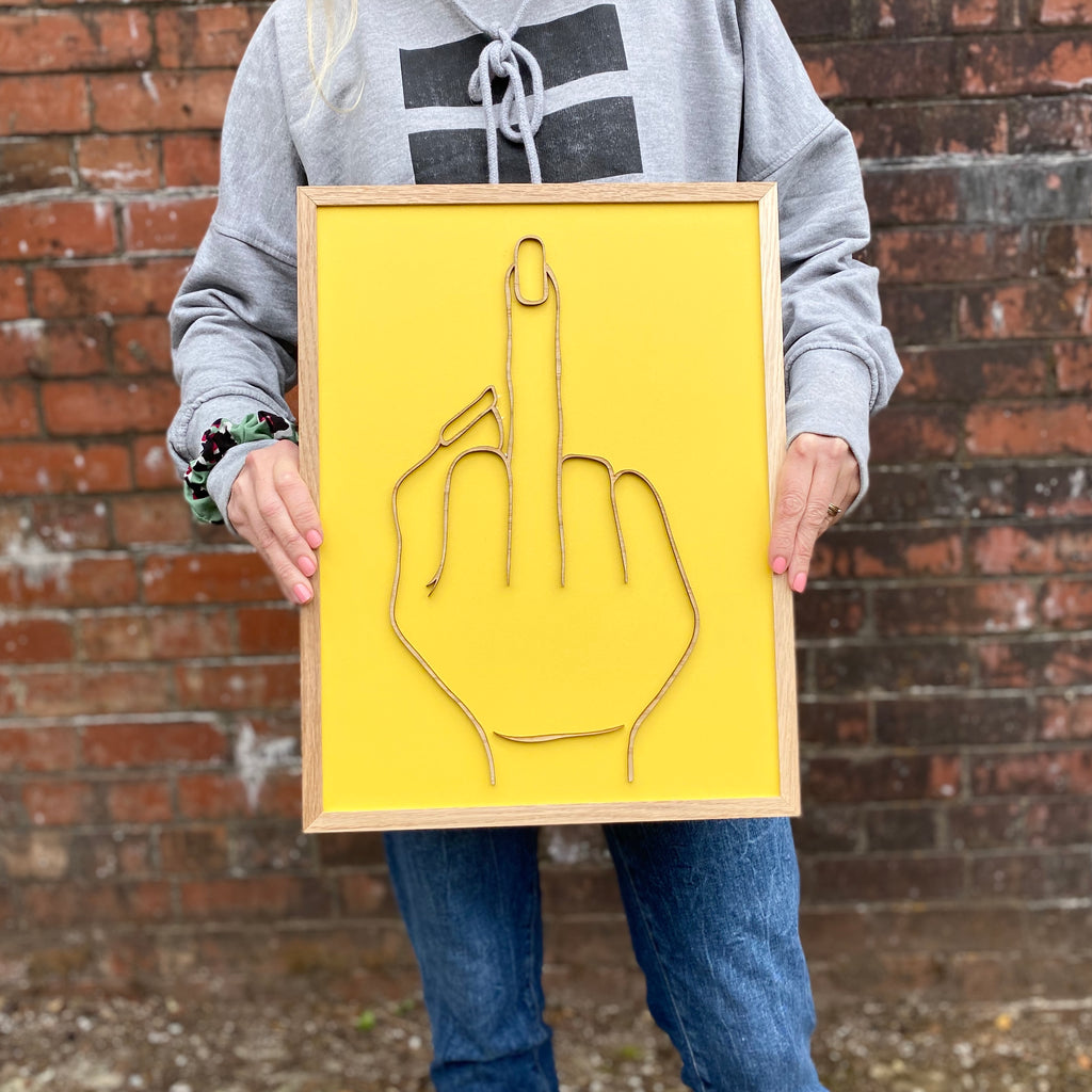 powerful yellow painted wooden gesture board with middle finger gesture over the top