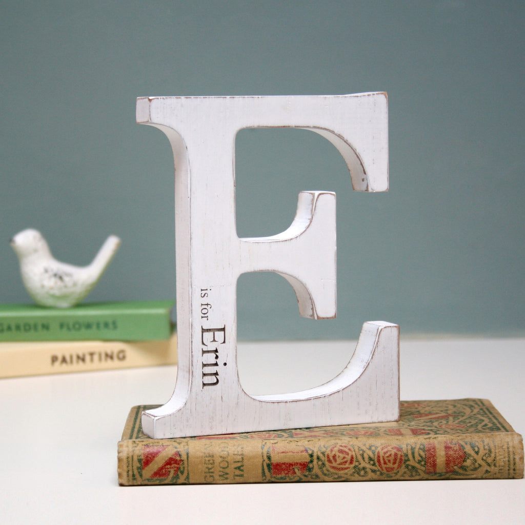 initial letter painted white with engraving of desired word eg 'erin'