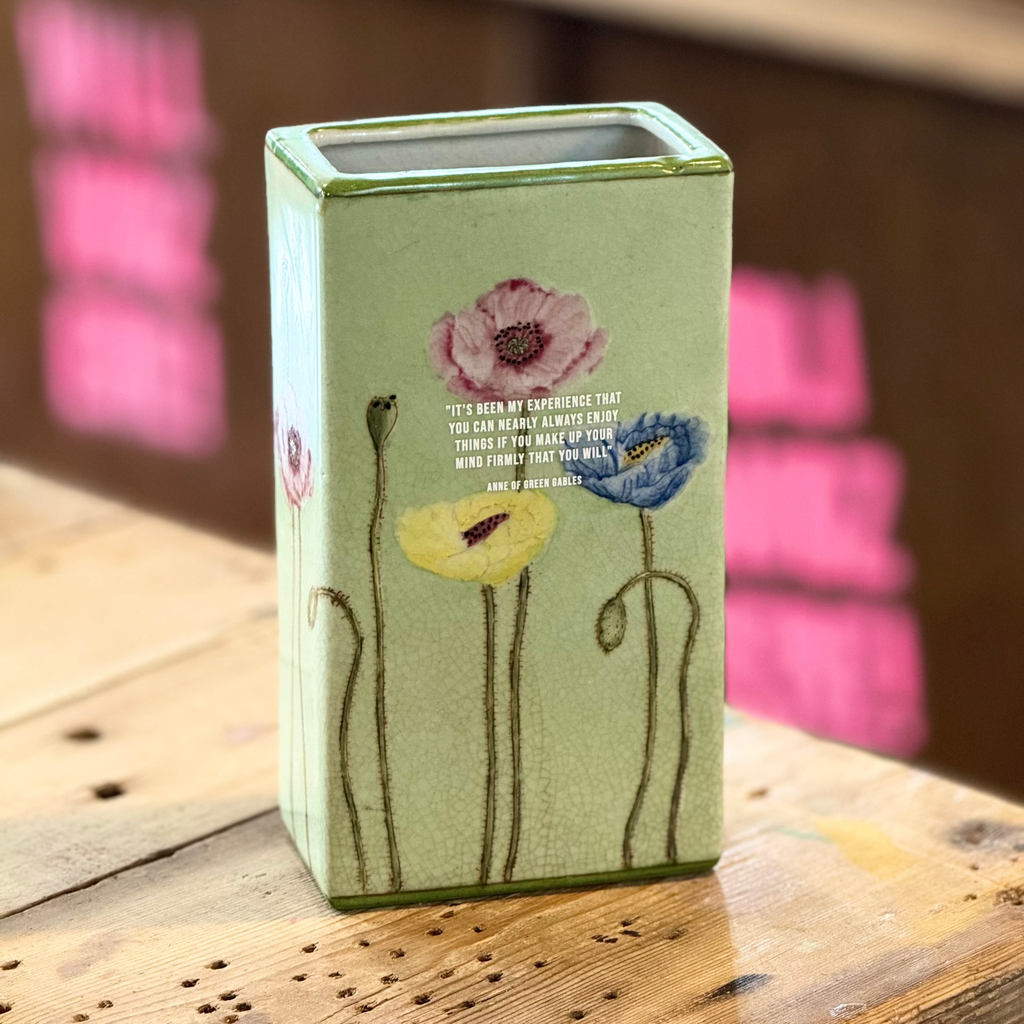 Rectangular ceramic vase with floral design on a wooden surface