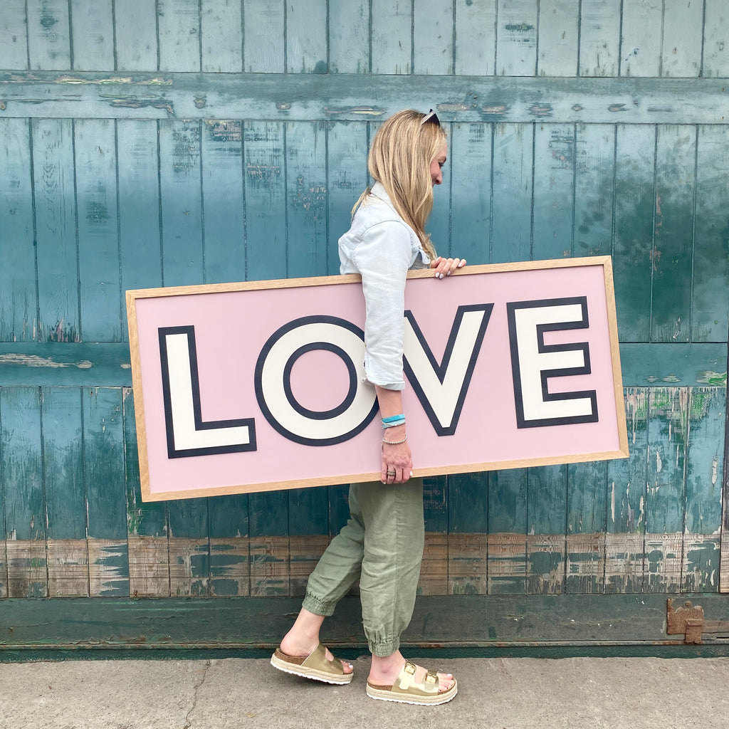 Love wooden word sign with surround shadow on dusty rose farrow and ball background