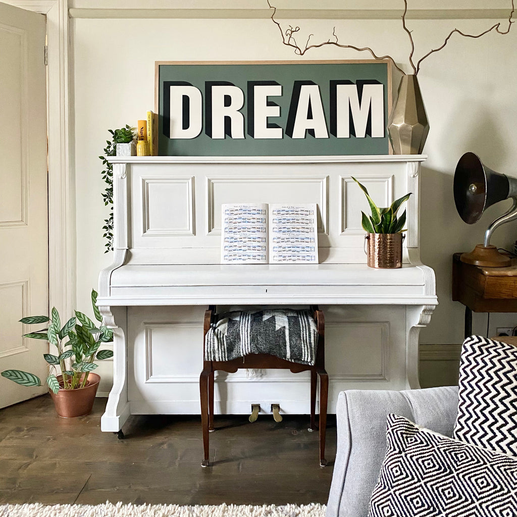 Bold wooden word art sign Dream in ball green farrow and ball on piano. Front room ideas