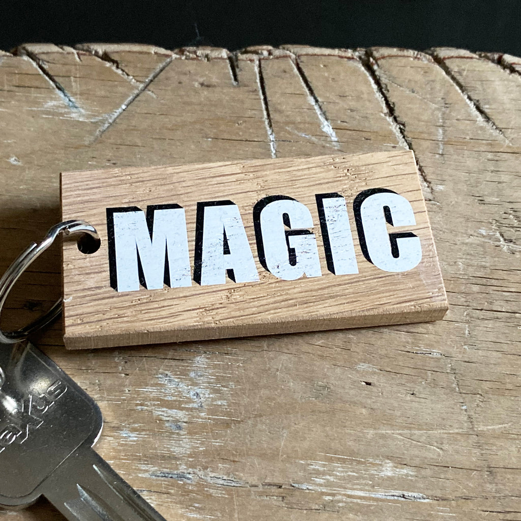 Wooden one word keyring reading 'Magic' in white box text with black drop shadow