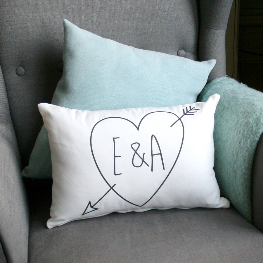 white pillow with heat pressed think lettered initials surrounded by a heart and arrow (cupid) eg 'E&A'